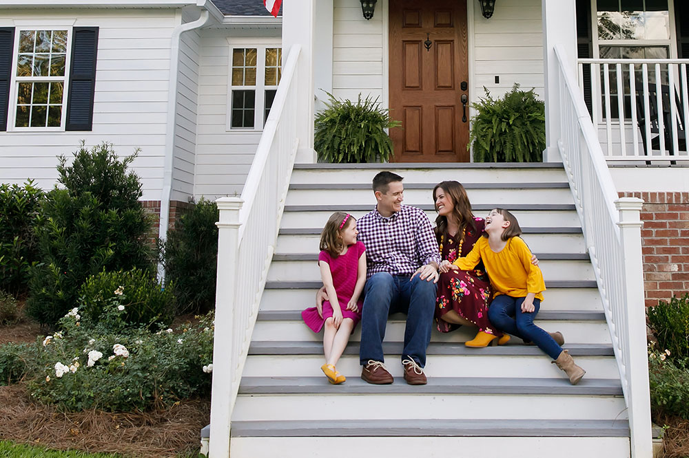 family in front of home