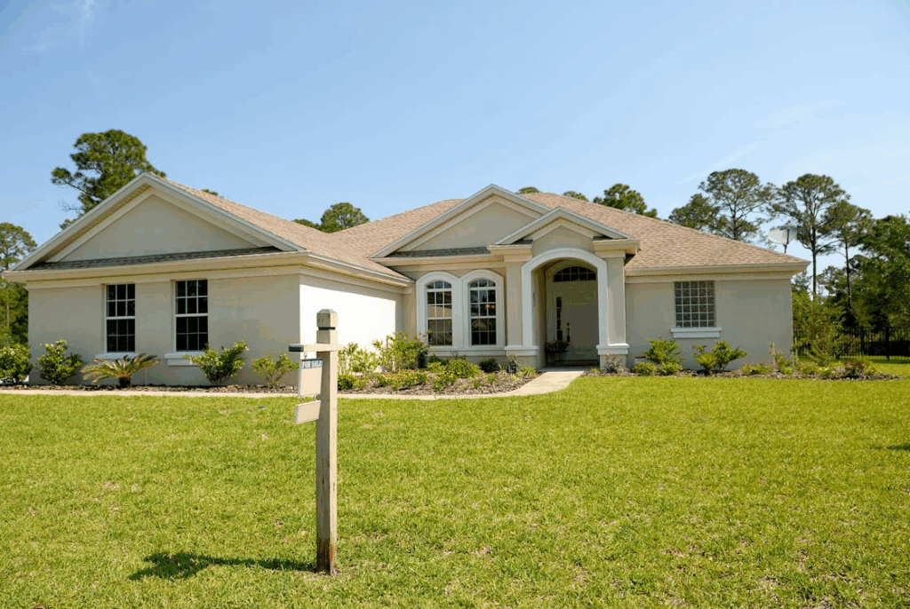 Photo of a house with a for sale sign in the yard
