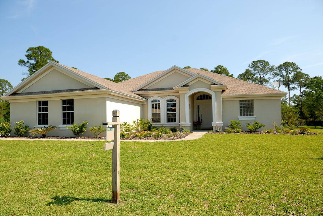 Photo of a house with a for sale sign in the yard